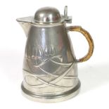 Liberty & Co: A Tudric Pewter Hot Water Jug, with a domed hinged cover, rattan covered handle,