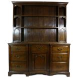 A George III Oak Enclosed Dresser, early 19th century, the rack with a dentil cornice above two