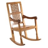 Mouseman: A Robert Thompson English Oak Rocking Chair, with two lattice back panels, shaped arms and