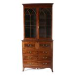 A Regency Mahogany, Satinwood Banded and Ebony Strung Secretaire Bookcase, early 19th century, the