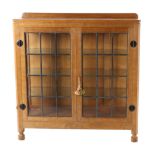 Mouseman: A Robert Thompson English Oak Display Cupboard, with raised upstand above leaded glazed