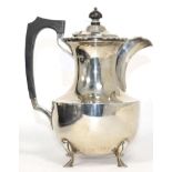 A silver hot water pot, James Dixon & Sons, Sheffield, 1933, of baluster form with ebonised handle