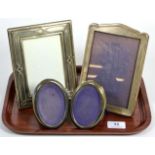 Two rectangular silver photograph frames; and a smaller pair of oval examples (4)