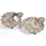 A pair of silver shell shaped dishes