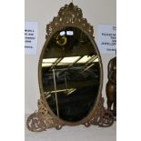 A 19th century dressing mirror in a pierced and foliate engraved brass frame, with easel back