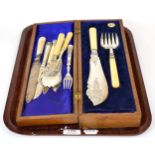 A pair of silver fish servers with ivory handles in a fitted case together with an assortment of