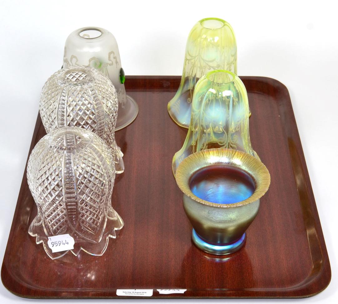 A pair of vaseline glass shades; three other; and an iridescent glass vase