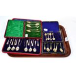 A set of twelve silver teaspoons and tongs, with shell terminals, in a fitted case; together with