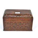 A carved oak two division tea caddy, with fitted interior