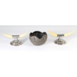 An Indian white metal bowl and a pair of Victorian white metal and ivory knife rests