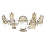 A pair of silver miniature throne chairs; together with various filigree miniature furniture; and an