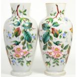 A pair of Victorian enamel painted opaque glass vases decorated with butterflies and flowers