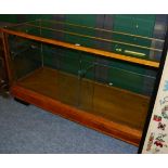 A 1930s brass and oak framed haberdashery cabinet