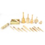 Assorted ivory, bone and ivorine spools, bodkins and four powder shakers including two ivory