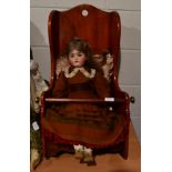 Victorian mahogany dolls rocking chair and a German bisque socket head doll (a.f.)