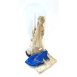 A Victorian wax shoulder head doll, with oval blue glass eyes, pierced ears hung with earrings,