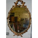 An 18th century style gilt oval mirror