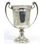 A silver twin-handled cup, Walker & Hall, Sheffield 'Presented to Old Calabar Club by Capt. T.W.H.