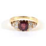 A Ruby and Diamond Ring, an oval cut ruby spaced by groups of three old cut diamonds, total