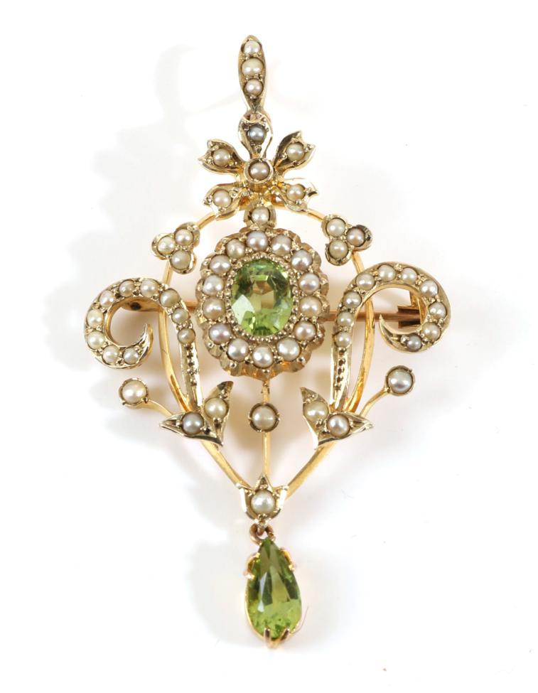 An Edwardian Peridot and Seed Pearl Brooch/Pendant, an oval cut peridot ...