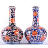 A Pair of Imari Porcelain Bottle Vases and Covers, 19th century, typically decorated with