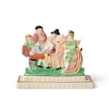 A Dillwyn & Co Swansea Porcelain Flatback Group, circa 1815, as figures about a table on a stepped