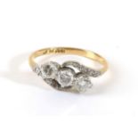 A Diamond Three Stone Ring, round brilliant cut diamonds in claw settings, to diamond set bypass