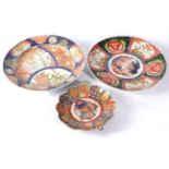 An Imari Porcelain Dish, Meiji period, of fluted circular form, typically painted with a basket of