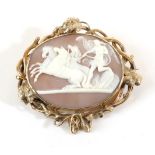 A Victorian Cameo Brooch, depicting Peace halting the horses of Mars, in a vine motif frame,