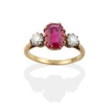 A Ruby and Diamond Three Stone Ring, a rectangular cushion cut ruby in a claw setting, between old