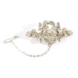 A Diamond Floral Brooch, an old cut diamond in a claw setting, spaced by diamond set leaves, total