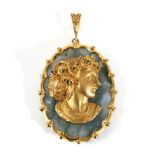 A 9 Carat Gold Moss Agate Cameo Pendant, a cast cameo depicting a female bust, with an emerald set