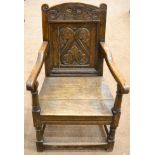 A 17th Century Joined Oak Wainscot Armchair, with carved top rail and back support above a boarded