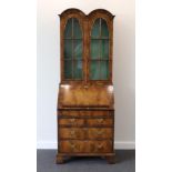 A 1920s Walnut and Feather-Banded Queen Anne Style Dome Top Bureau Bookcase, with glazed doors
