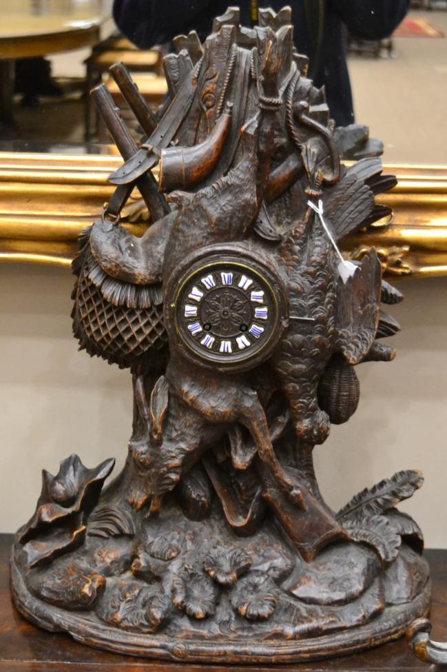 A Carved Black Forest Striking Mantel Clock, circa 1880, carved case depicting a hunting theme,
