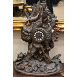 A Carved Black Forest Striking Mantel Clock, circa 1880, carved case depicting a hunting theme,