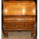 A 1920/30s Walnut and Featherbanded Bureau, in George II style, the fall front enclosing an