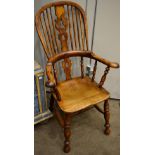 A Mid 19th Century Yew Smoker's Armchair, the spindle back and pierced splat above a moulded seat,