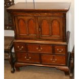 A Miniature Joined Oak Press Cupboard, the moulded top above two fielded cupboard doors all