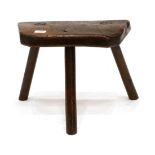An Early 19th Century Elm Primitive Stool, on three splayed legs, 39cm by 30cm