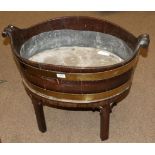 A George III Mahogany and Brass Bound Wine Cooler, of oval staved construction, with removable