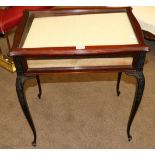 An Edwardian Carved Mahogany Bijouterie Table, early 20th century, the glazed hinged lid above blind