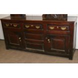 An Early 18th Century Oak Enclosed Dresser, with three frieze drawers above two fielded panels