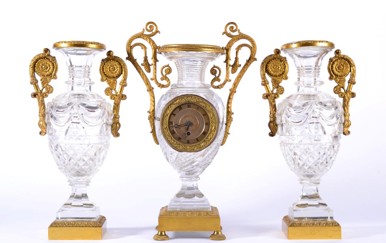 An Ormolu and Cut Glass Mantel Timepiece with Garniture, 19th century and later, urn shaped cut