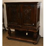 A 1920/30s Carved Oak Cupboard, with parquetry decorated top and linen fold side panels, the two