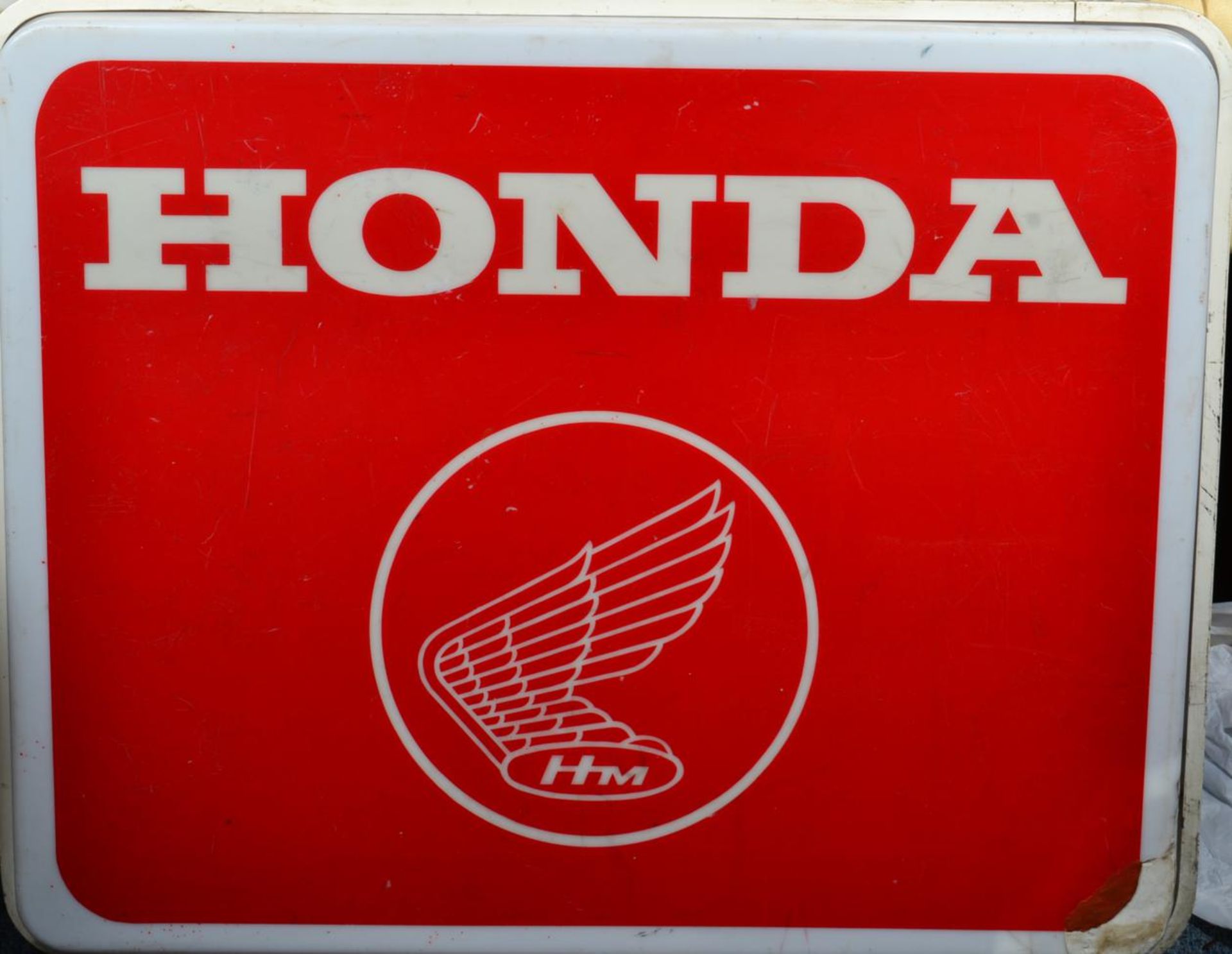 A HONDA Illuminated Perspex Advertising Sign, decorated with a winged emblem and the letters HM,