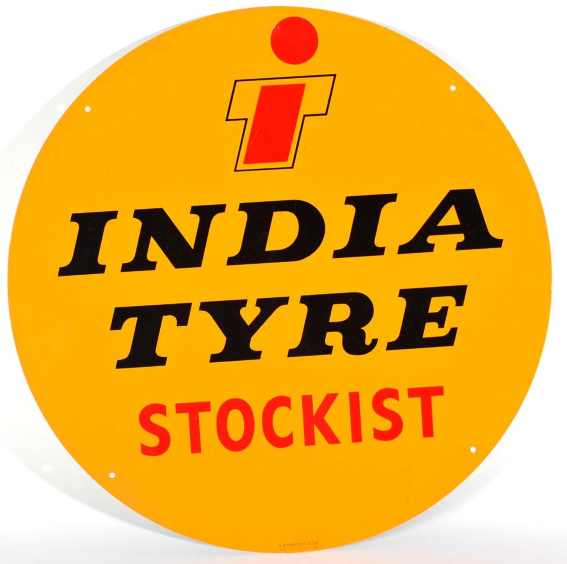 A Single-Sided Circular Metal Advertising Sign: INDIA TYRE STOCKIST, with four drill holes, the base