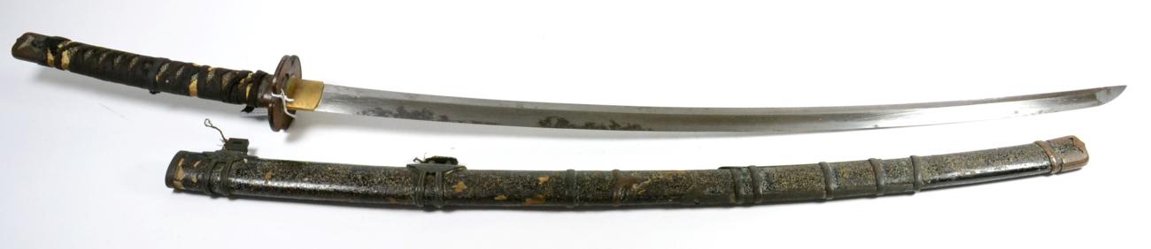 A Shinto Japanese Tachi, the 77.5cm blade with broad undulating hamon, the one piece brass habaki