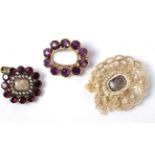 A garnet and seed pearl mourning brooch, an amethyst mourning brooch and a seed pearl mourning