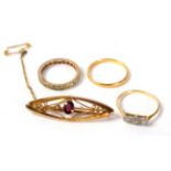 A 22 carat gold band ring, 2.3g; a diamond three stone ring; a paste eternity ring; and a garnet
